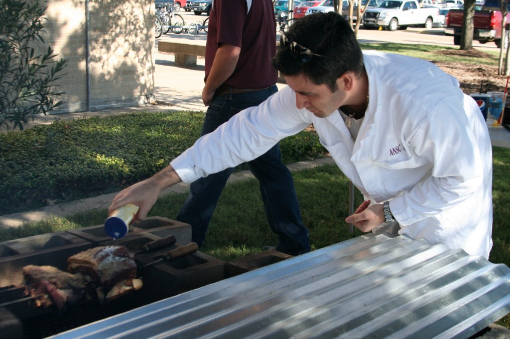A Texas A&M student prepares BBQ during a meat science class.