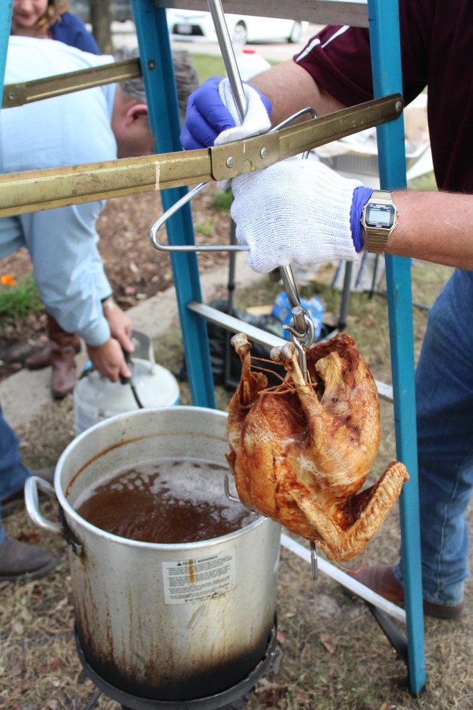 Pulling turkey out of cooking oil (photo by Kathleen Meredith)