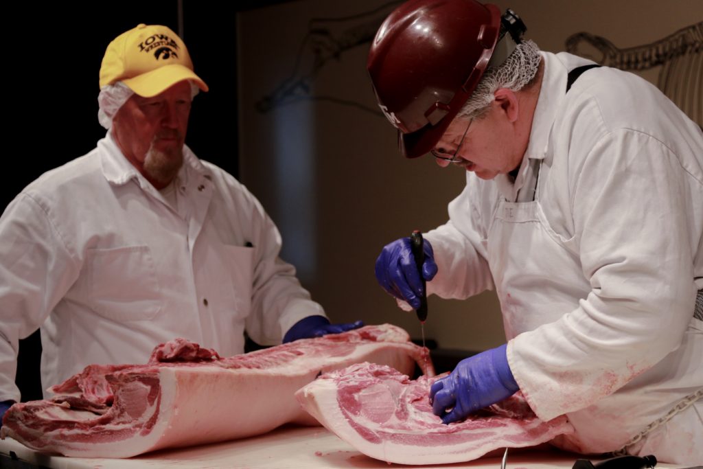 Jim Murray, National Pork Board, and Davey Griffin, Texas A&M University demonstrating pork carcass cutting at the Center of the Plate workshop