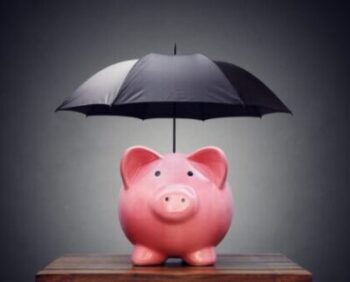 Picture of piggy bank holding an umbrella