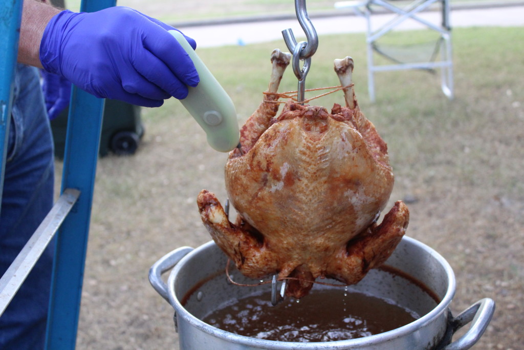Checking temperature of fried turkey (photo by Kathleen Meredith)