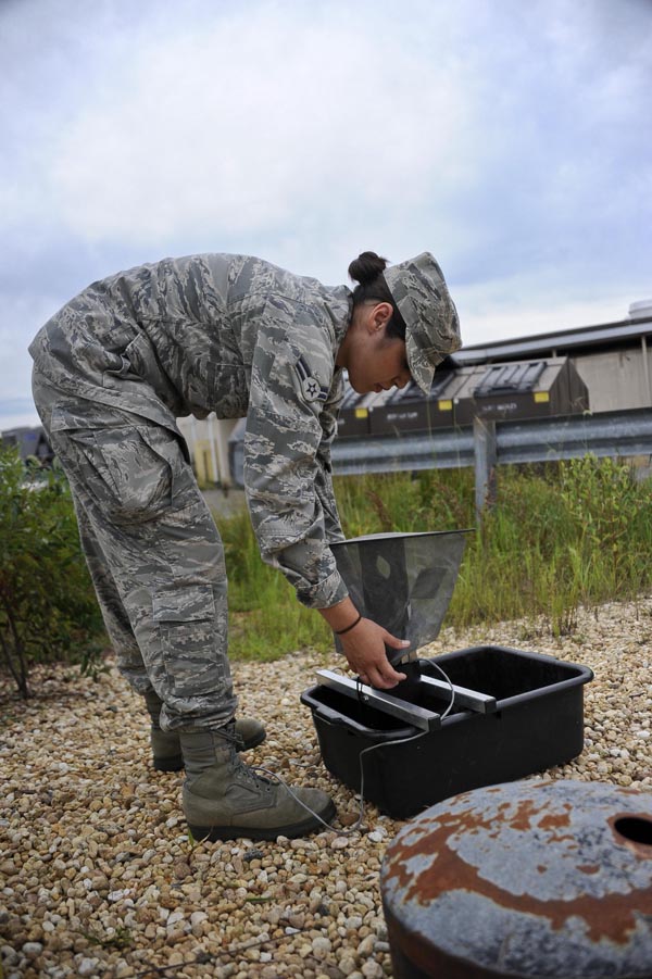 Military airman prepares a stink trap to catch Culex mosquitoes for testing.  Photo courtesy Joint Base McGuire-Dix-Lakehurst, USAF.