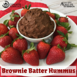 Brownie Batter Hummus recipe surrounded by fresh washed strawberries for dipping.