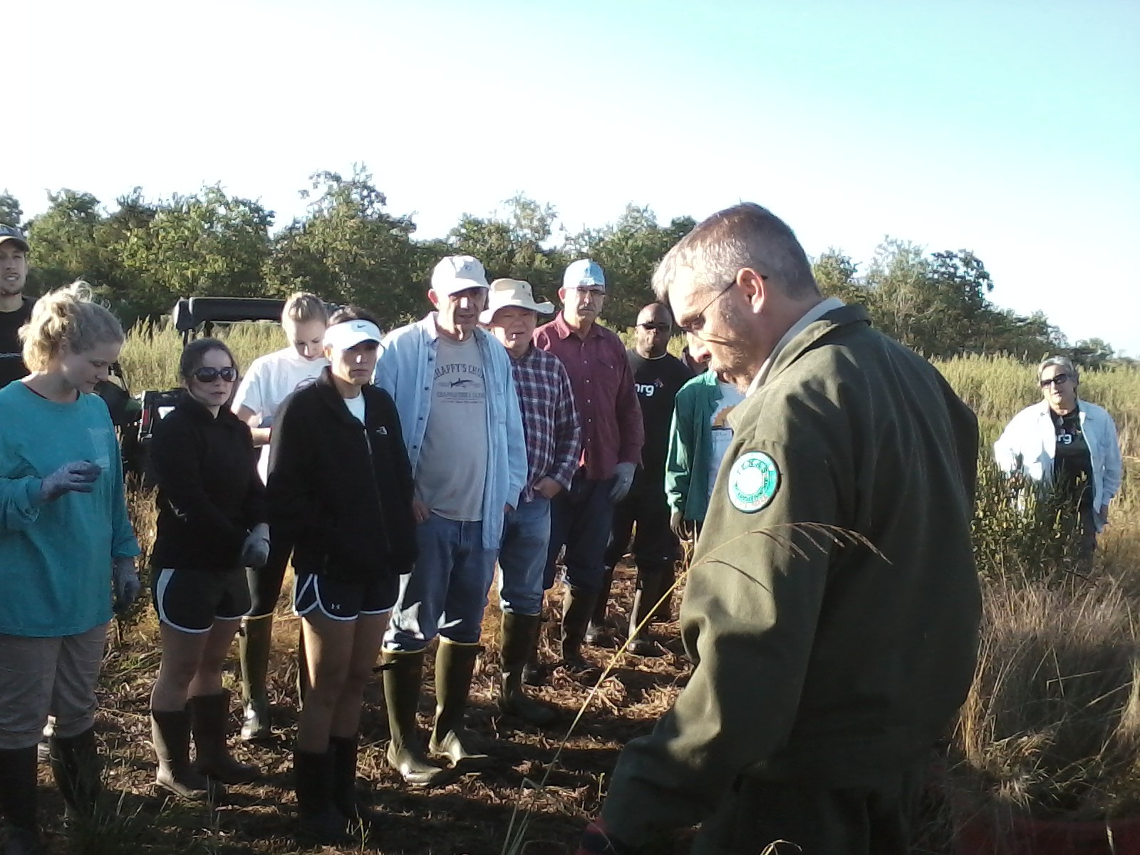 TPWD Ranger teaching volunteers about prairie restoration